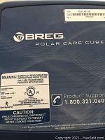 Top view of the blue Breg Polar Care Cube medical cold therapy device with product support phone number and warning labels.