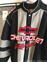 Close-up front of Chevrolet Racing bomber jacket showing logo and red embroidered text