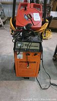 Full frontal photo of Chicago Electric Power System battery charger and starter unit with cords and controls visible