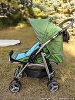 Side profile of the green Bumbleride Indie stroller showing reclining seat and wheels