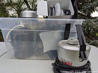 Magic Bullet Bullet Express components stored in clear plastic tote, showing parts and base with cable