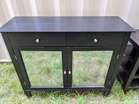 Front view of sideboard cabinet showing two drawers and two doors with antiqued mirrored glass panels