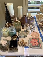 Overall photo showing assortment of candles, aroma diffuser, manger scene figurines, decorative boxes, and coasters.