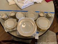 Overview of stacked plates, bowls and cups on table