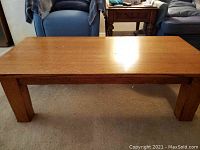 Front view of rectangular wood coffee table showing surface and legs