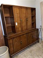 Front view of the full two-piece hutch showing the wood grain finish, closed cabinets, and side shelving