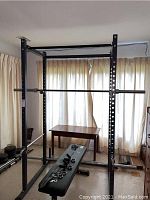 Front view of assembled weight lifting rack with one bar and bench