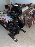 Overall view of black steel weight rack with plates