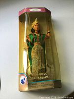 Barbie doll in original clear plastic box with gold-tone borders, dressed in traditional Thai costume inside packaging.