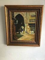 Full view of the framed painting showing the street scene and artist signature.