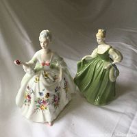 Front view of both Royal Doulton figurines Fair Lady and Diana depicting detailed color and design on dresses.