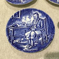 Close-up of Enoch Wedgwood miniature blue and white ceramic plaque featuring a Huntsman seated with a dog, holding a drinking glass.