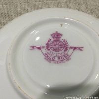 Close-up of the Minton Gold Rose backstamp on bottom of cup confirming brand, pattern, and origin.