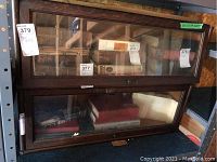 Front view of two-tier oak barrister bookcase with books inside