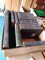 Set of 11 hardcover books from series World's Best Histories, mostly dark brown covers with one green cover. Books are inside a cardboard box.
