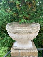 Front view of cement planter showing bowl and pedestal base