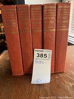 Five vintage hardcover books with red covers titled The War on All Fronts, showing the spines with gold lettering and author names.