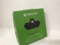 Green retail box with Xbox One branding and image of the stereo headset adapter.