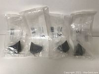 Four individual graphite metal cabinet knobs in clear packaging, all sealed