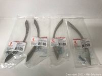 Four Richelieu hardware metal pulls in brushed nickel, each in original plastic packaging.