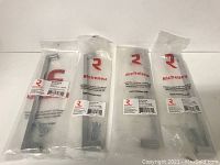 Four brand new Richelieu chrome metal pulls in original packaging with included screws