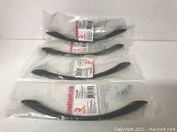 Four matte black Richelieu metal pulls, each individually packaged and sealed with original Richeliu label and screws included.