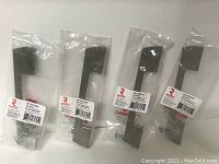 Four Richelieu metal pulls in original packaging, each with a barcode label visible and clearly marked 128mm center to center.