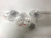 Four plastic cabinet knobs in original plastic packaging, showing the set as new and unopened.