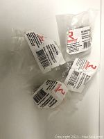 Four individually packaged metal cabinet knobs by Richelieu Hardware, natural iron finish, with labels visible.