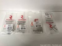 Four packaged Richelieu cabinet knobs in individual clear bags, brand and product labels visible