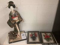 Photo showing the Japanese decorative doll in traditional kimono on wooden base alongside the two framed Capodimonte floral plaques.