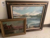 Two framed vintage fishing paintings, one larger behind smaller, showing detailed landscape and water scenes
