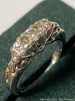 Angled view showing three diamonds and band detailing