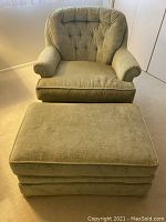 Front view of green armchair and ottoman on carpet