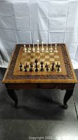 Front view of square chess table with chess pieces set up