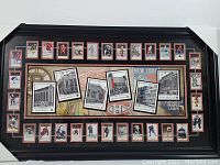 Full frontal image of the framed memorabilia showing all components inside the frame including arena illustrations and player photos around.