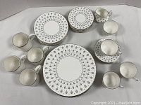 Overview of plates, saucers, tea cups and mugs arranged on table