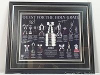 Full view of the framed Quest for the Holy Grail print showing NHL trophies and six player autographs.