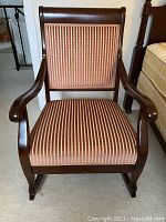 Front view of rocking chair showing upholstered backrest and armrests