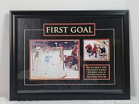 Full view of framed memorabilia showing larger signed photo, smaller goal moment photo, and plaque.