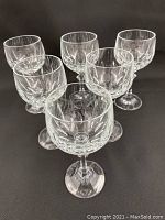Six Waterford crystal wine glasses arranged in triangular formation, showing overall shape and cut pattern.
