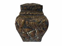 Front view of antique silver plated box showing intricate raised butterfly and floral designs with aged patina.