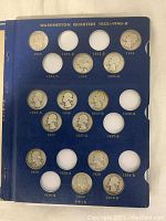 Blue album page for Washington quarters 1932–1940-D showing slots for coins dated 1932–1940 with several coins in place