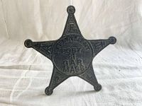 Front face of the black cast iron star-shaped cemetery marker post showing raised text and inscriptions indicating Grand Army of the Republic Post 81 Massachusetts.