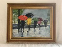 Front view of framed oil painting showing five figures with colorful umbrellas walking on wet pavement