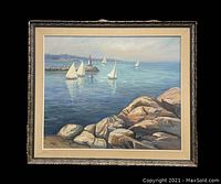 Full view of framed oil painting showing harbor scene with sailboats and rocks