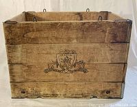 Front view of the wooden crate showing a black-printed logo crest with lion and dogs and the text 'Established 1831 Incorporated 1883'