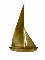 Front view of the brass sailboat statue showing its tall sails and smooth surface.