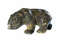 Side view of dark polished stone bear figurine showing natural color variations and carved details.