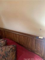 Wide view of the oak bed headboard showing its width and wood panel design.